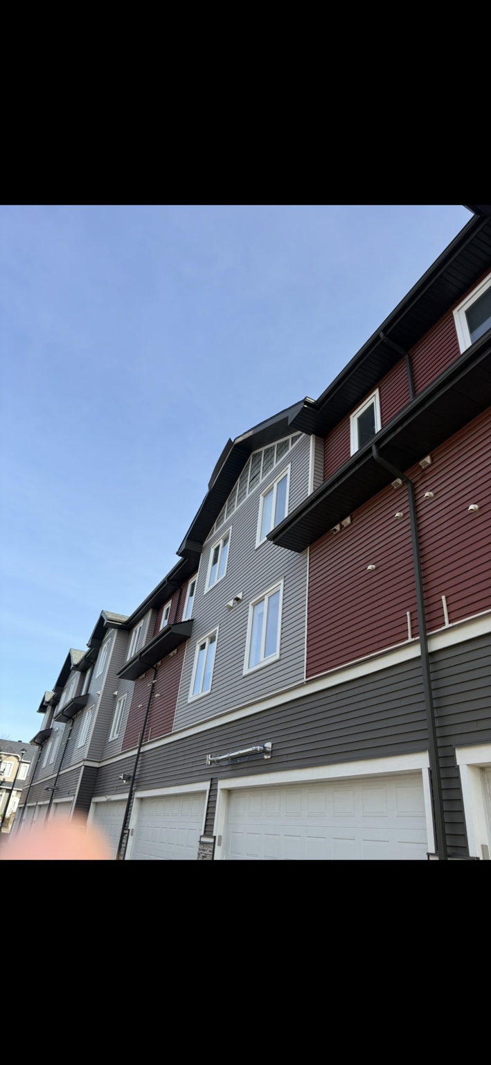 Wind-damaged fascia on a townhouse building