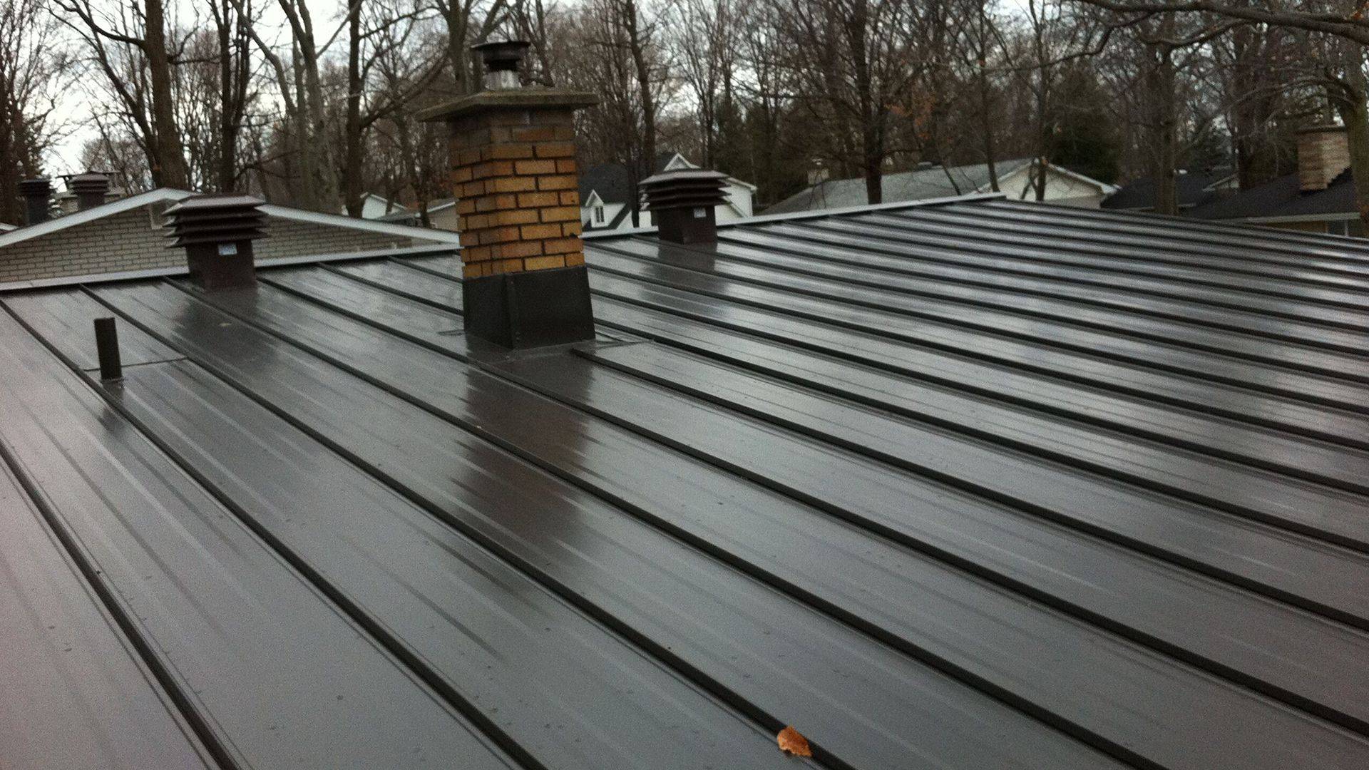 Standing-seam metal roof around chimney and ventilation details