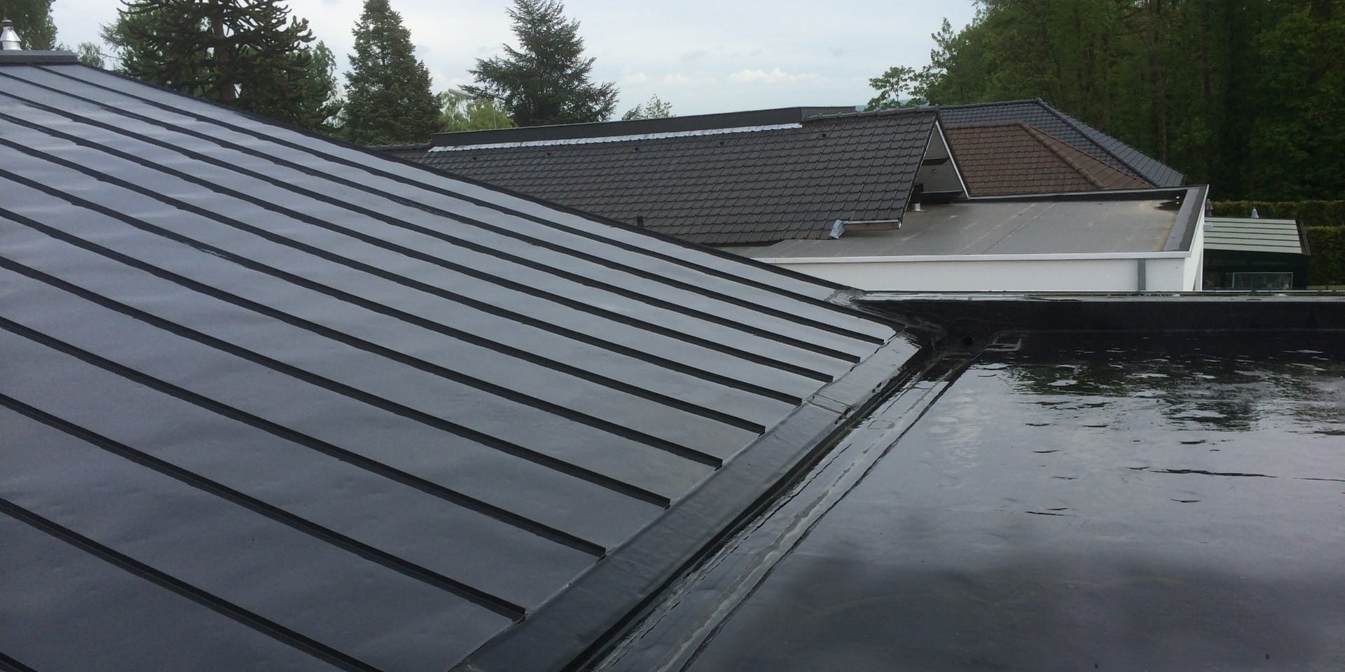 Metal roofing and adjacent low-slope roof junction