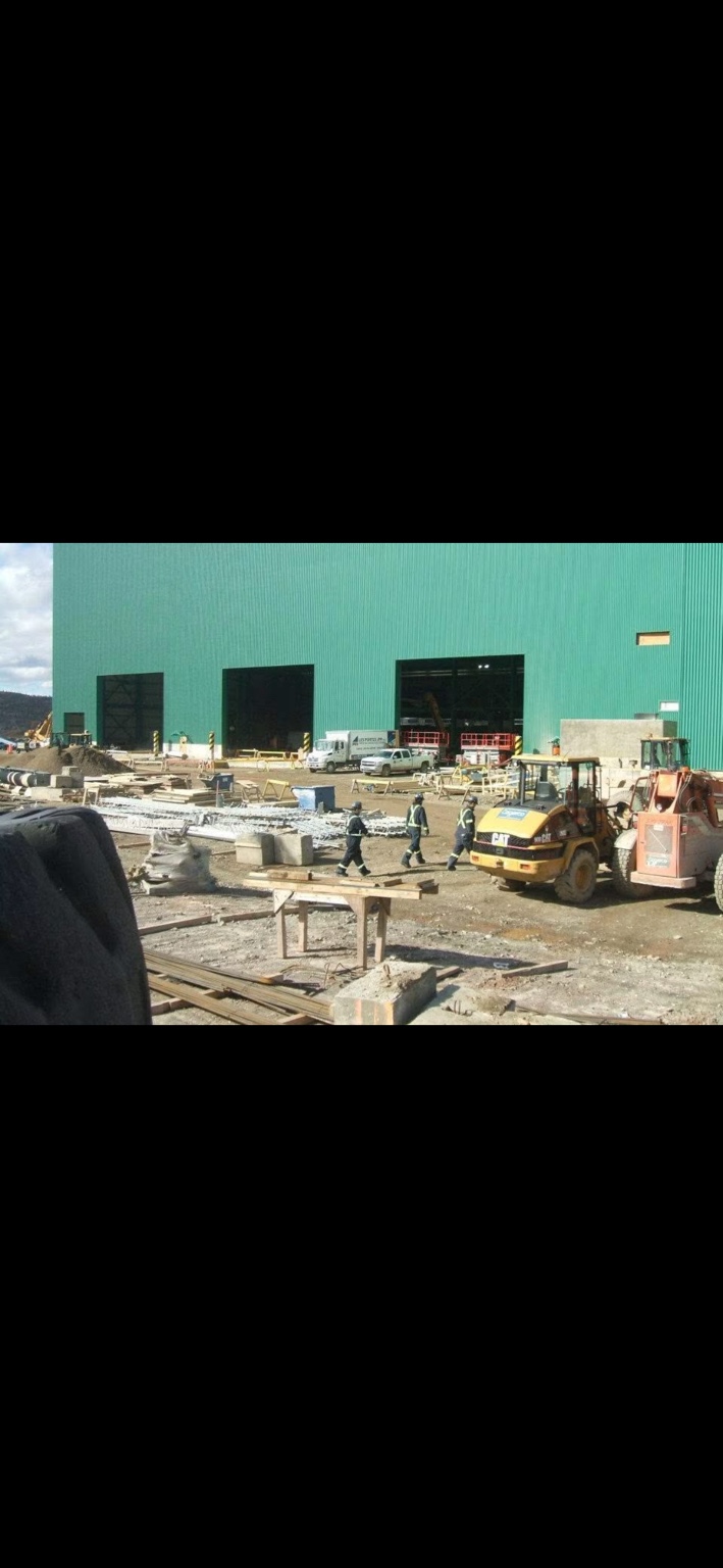 Industrial building exterior and active construction site