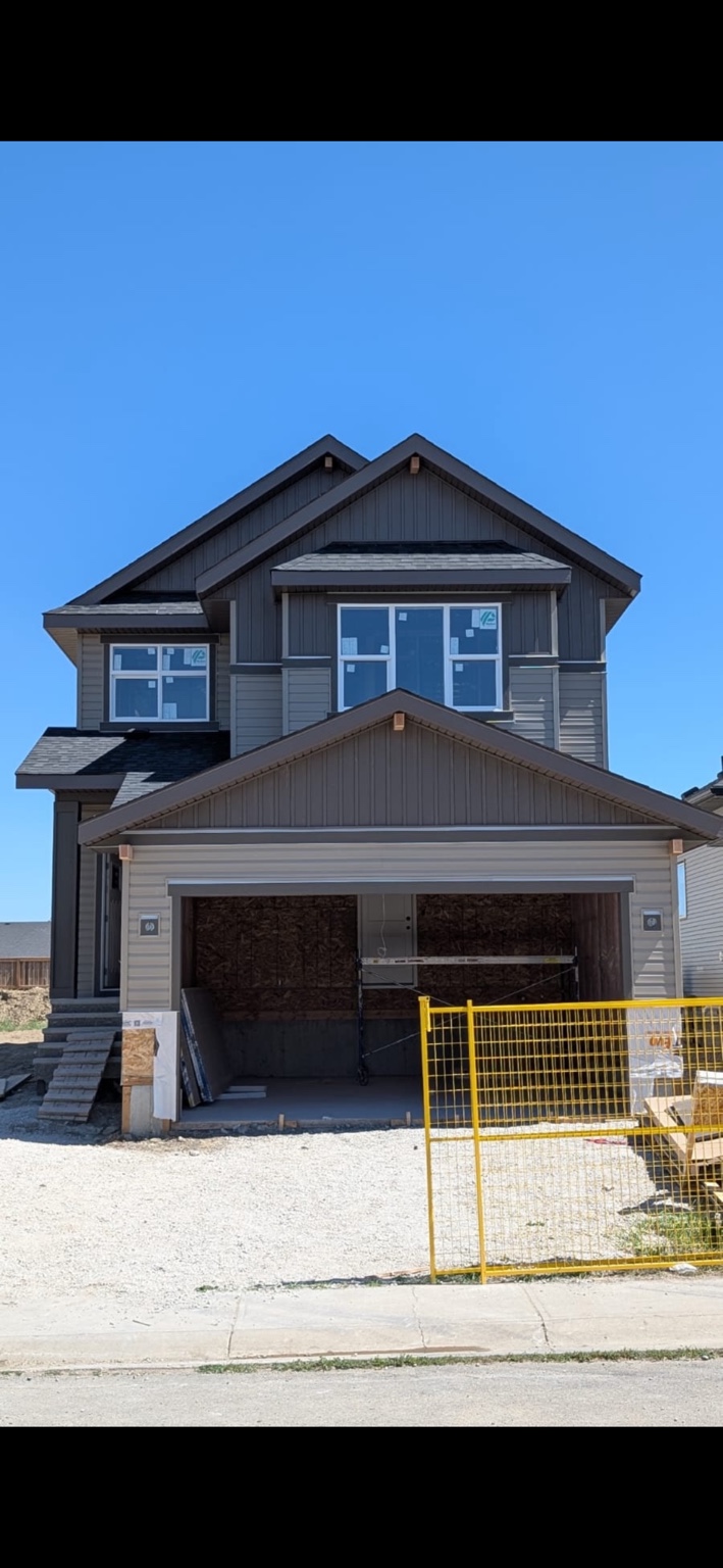 Front elevation with horizontal siding and vertical gable accents