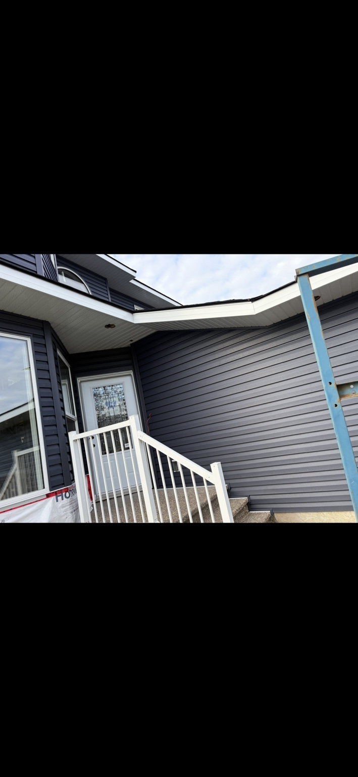 Entry soffit and fascia with coordinated blue siding
