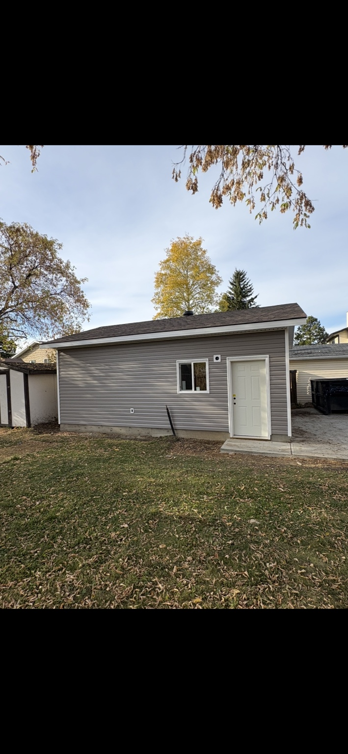 Detached garage side elevation with entry door and window