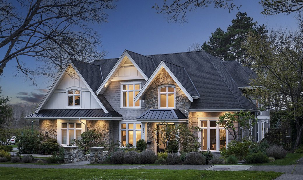 Finished home with stone, siding and landscaped grounds